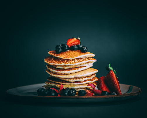Agave syrup, a natural sweetener, on top of pancakes and berries